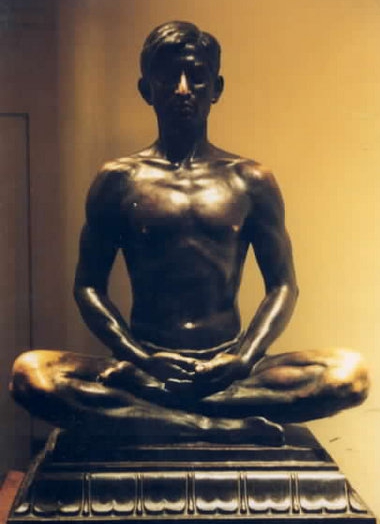 Bronze statue of man in half-lotus