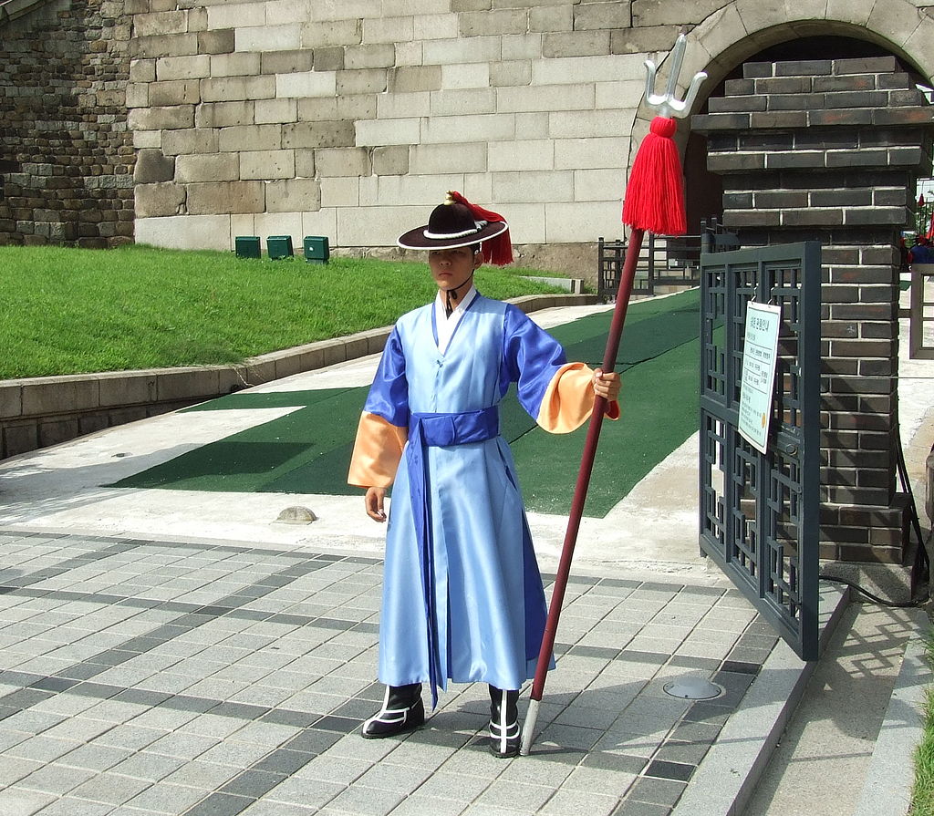 Korean guard standing at Namdaemun holding a dangpa (trident).